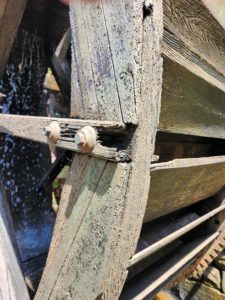 The wooden spokes of the waterwheel at Yates Mill are rotting.